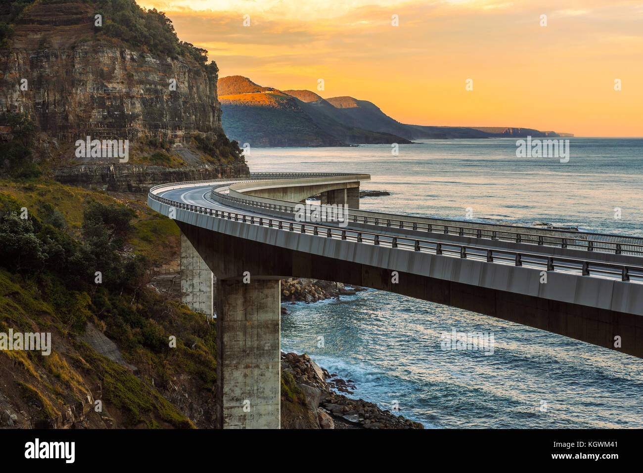 Sunset over the Sea cliff bridge along Australian Pacific ocean Stock Photo