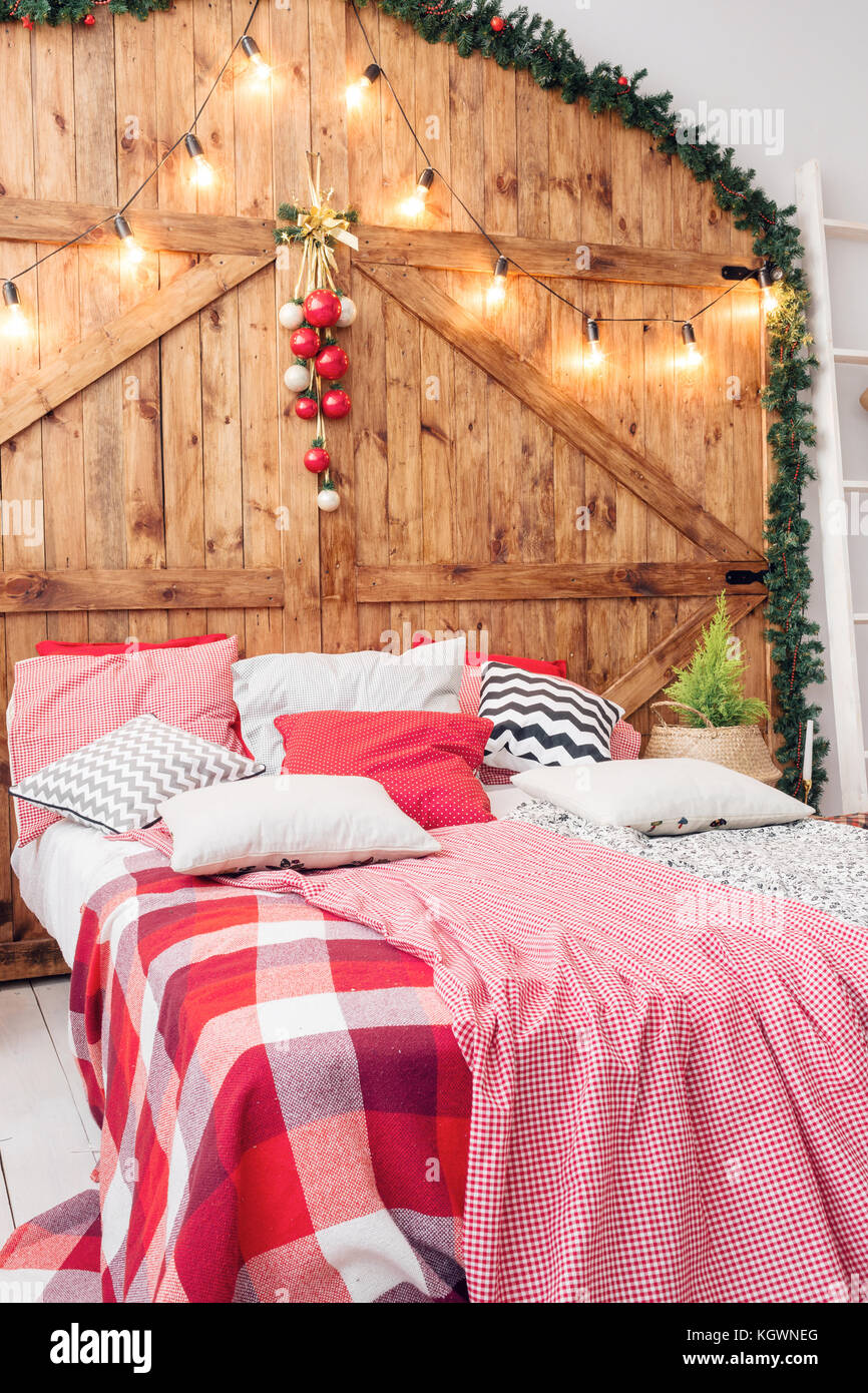 Xmas in morning bedroom. Double bed In christmas Interior on wood Xmas in morning bedroom. Double bed In christmas Interior on wood