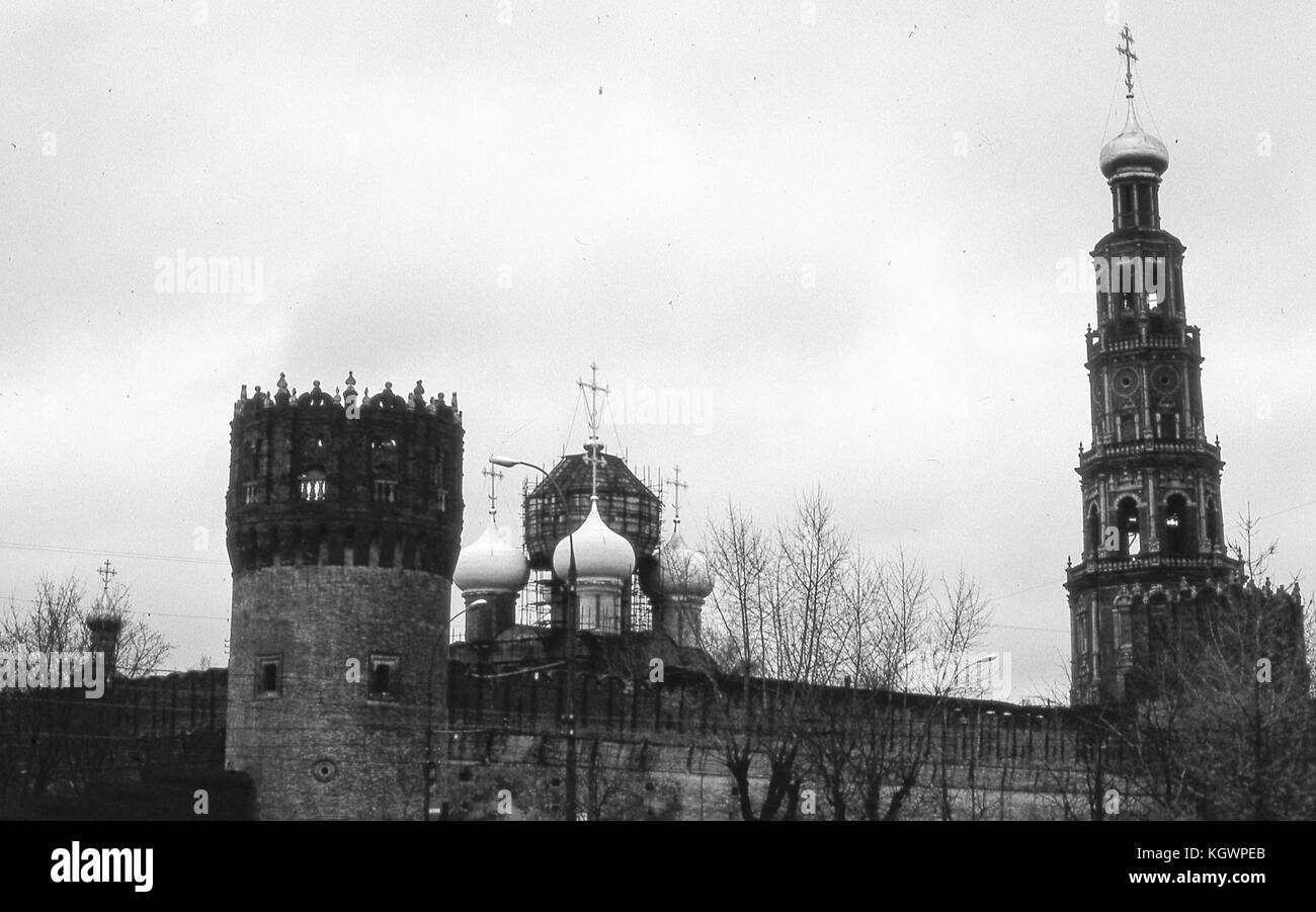View facing northwest of church buildings within the walls of the Novodevichy Convent complex, in Moscow, Soviet Russia, USSR, November, 1973. From left to right: the Chebotarnaya Tower, the Cathedral of Our Lady of Smolensk, and the Belfry with the Church of Saints Barlaam and Josaphat. () Stock Photo