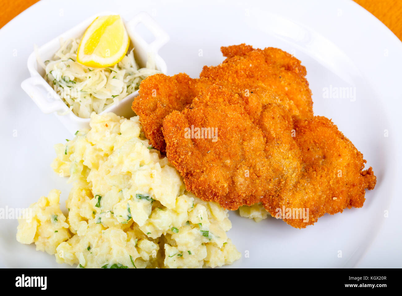 Czech cuisine - schnitzel with cabbage and lemon Stock Photo - Alamy