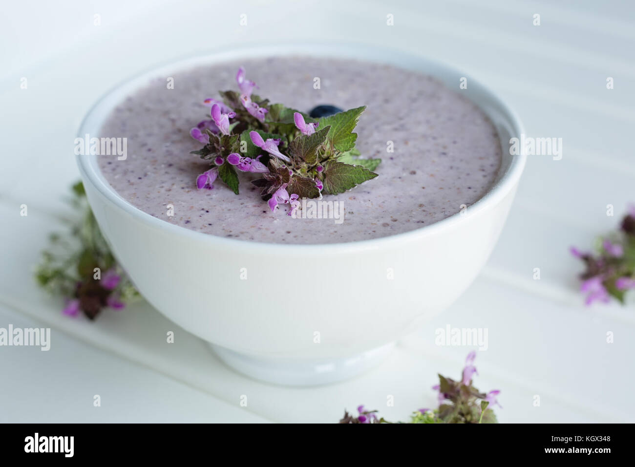 Oatmeal porridge made of oats, mashed banana, almond milk and berries