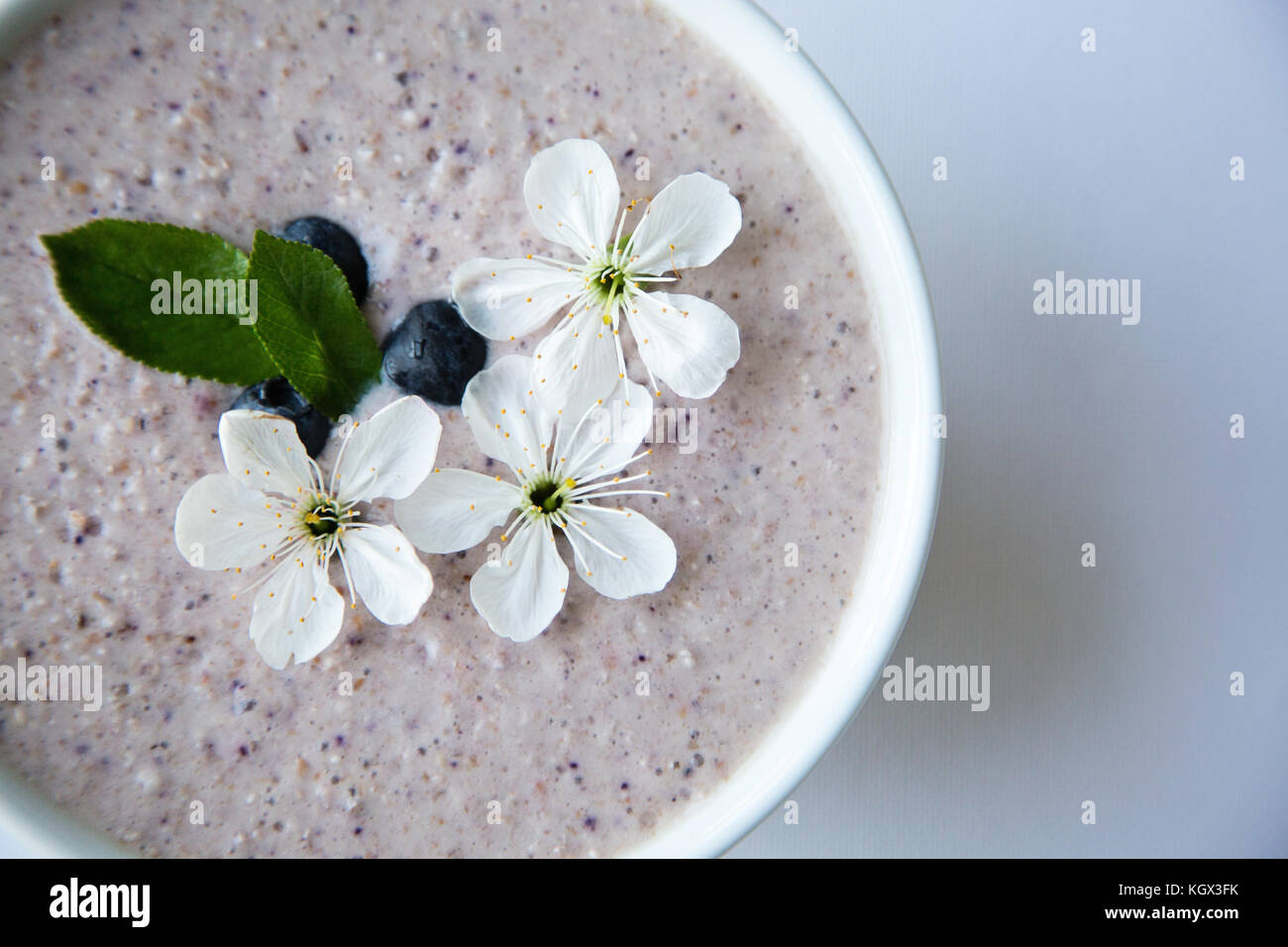 Oatmeal porridge made of oats, mashed banana, almond milk and berries