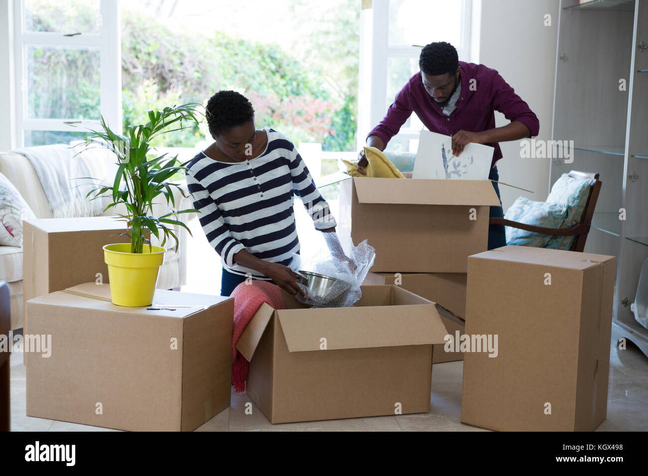 Couple unpacking boxes in new house Stock Photo