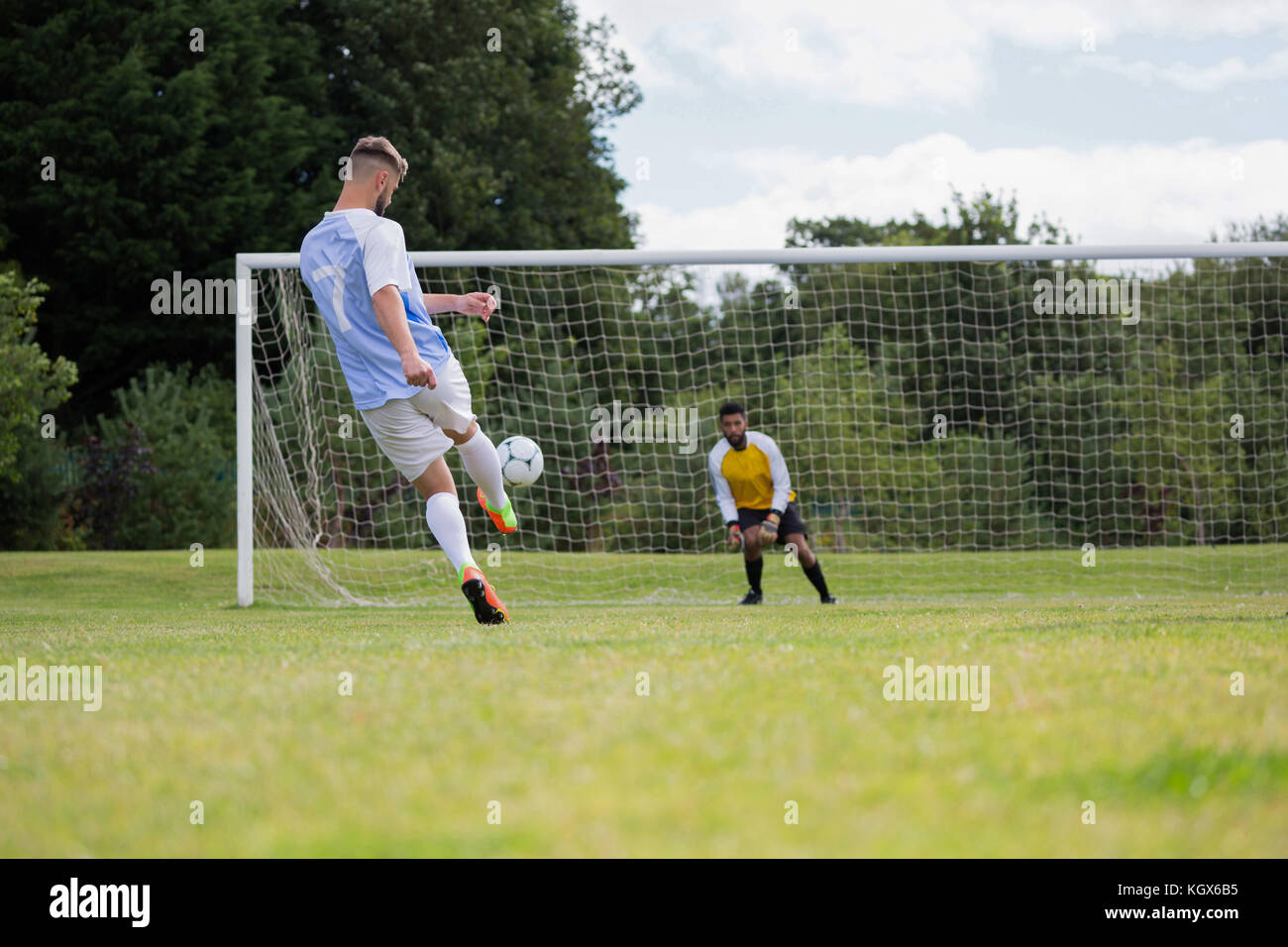 Soccer Player Kicking Ball Towards Goal Post In Ground Stock Photo Alamy Soccer Player Kicking Ball Towards Goal Post In Ground Stock Photo Alamy