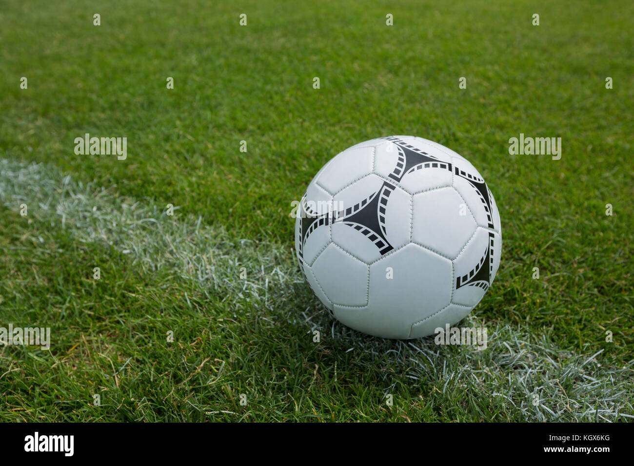 Soccer ball on white marking line at football stadium Stock Photo - Alamy