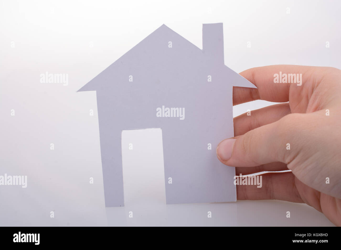Hand holding a paper house on a white background Stock Photo - Alamy