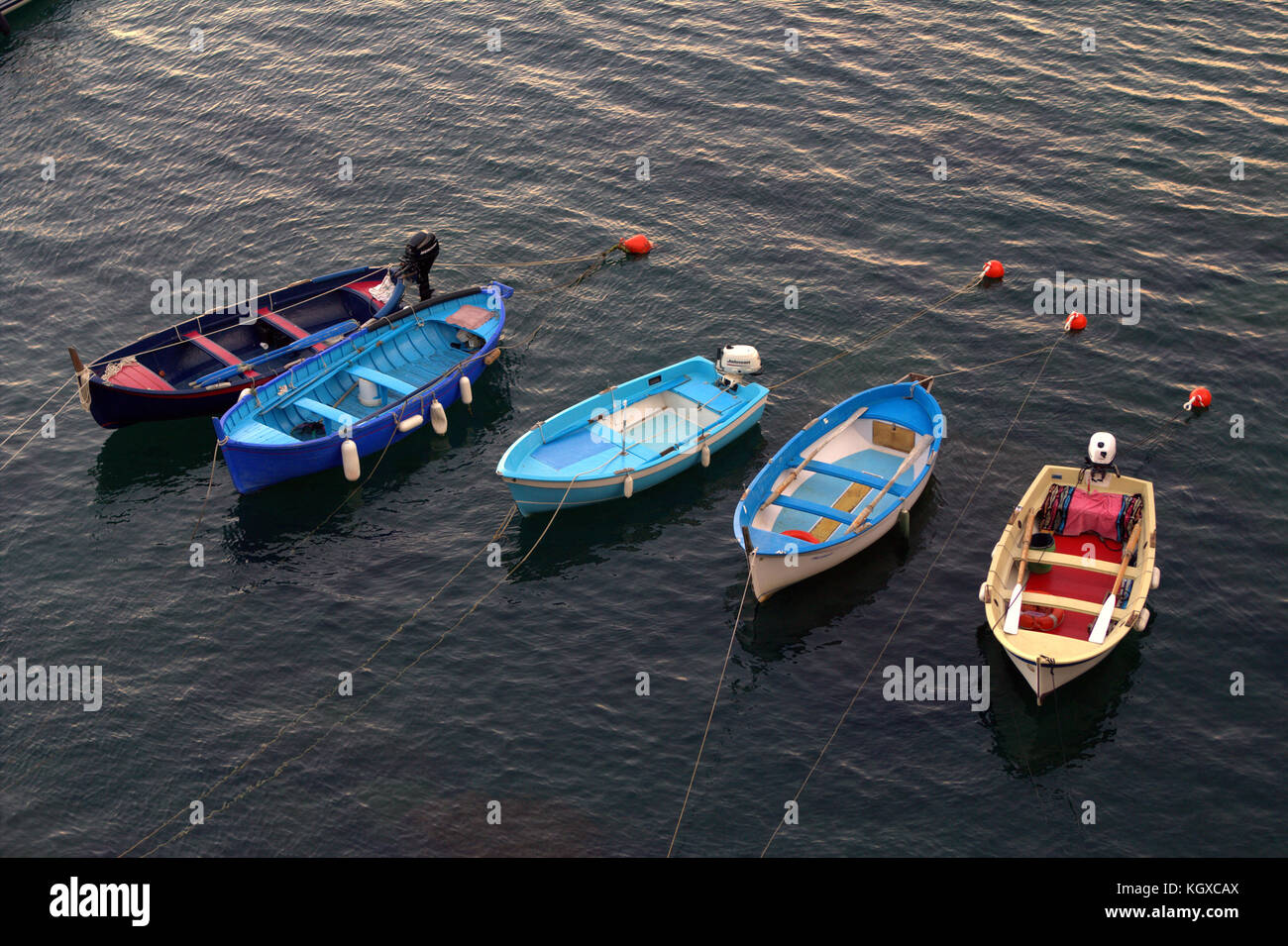 small colorful row boats floating with buoys Stock Photo