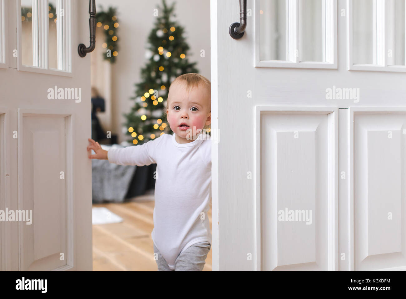 Charming kid in doorway of cozy bedroom Stock Photo