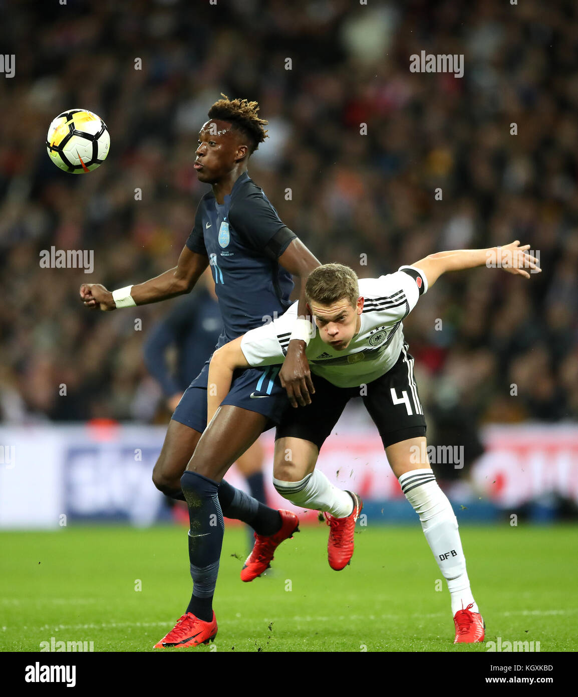 England's Tammy Abraham (left) and Germany's Matthias Ginter (right) battle for the ball during the International Friendly match at Wembley Stadium, London. Stock Photo