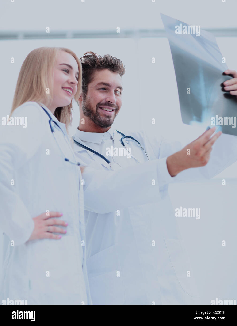 Closeup portrait of intellectual healthcare professionals with white labcoat, looking at full body x-ray radiographic image Stock Photo