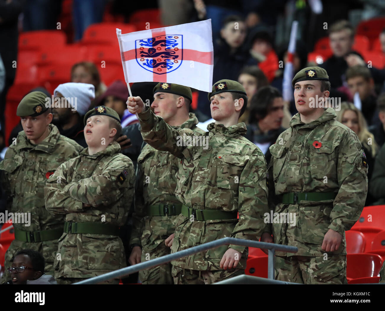 A member of the armed forces waves a three lions St Georges flag during the International Friendly match at Wembley Stadium, London. Stock Photo