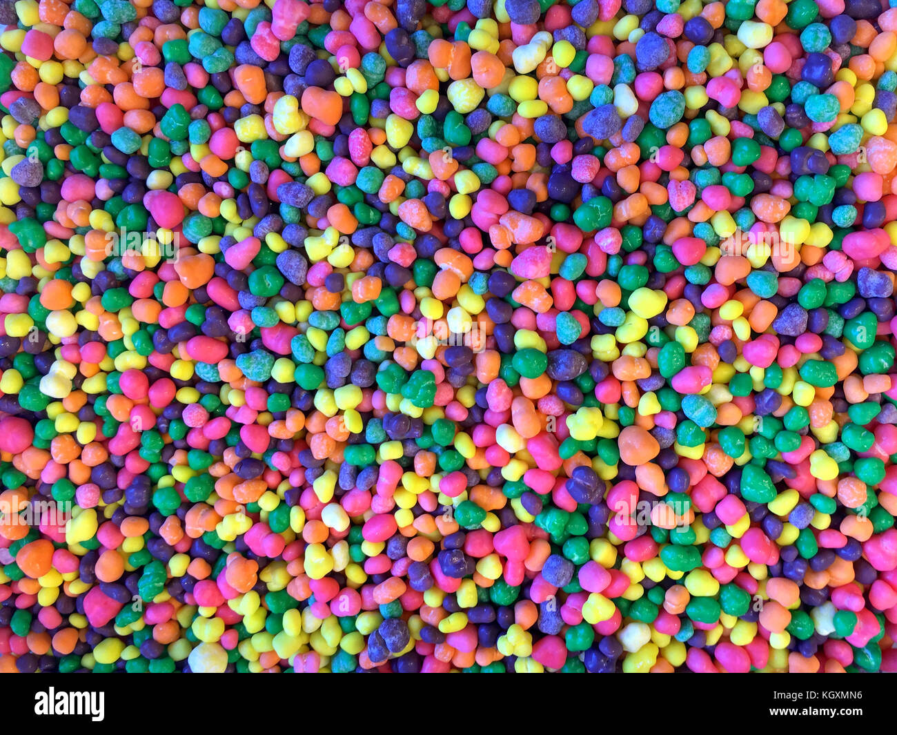 Close up on many colorful candy pieces. Bright colorful florescent colors. Flat lay top view background Stock Photo