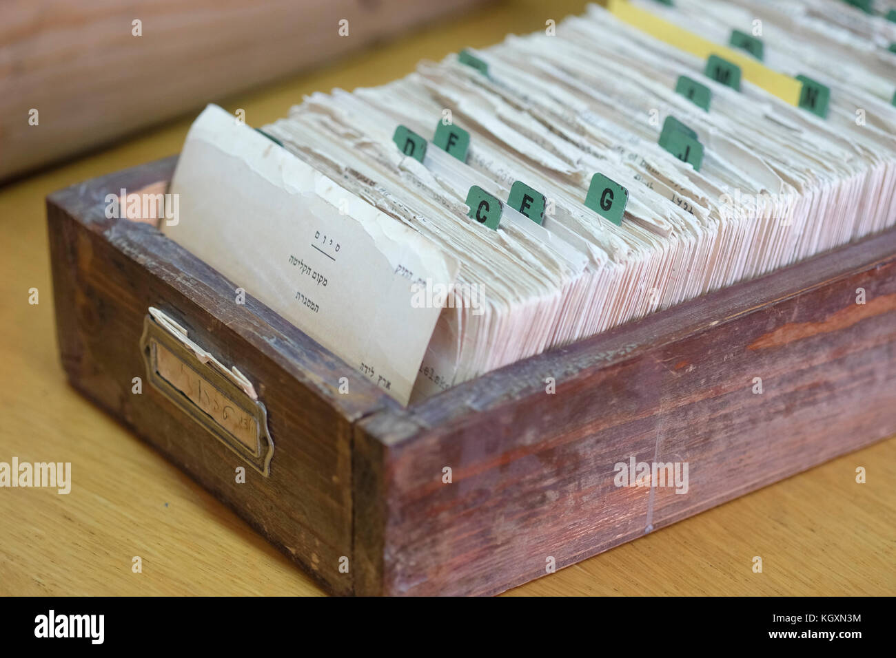 A wooden library card catalogue drawer filled with cards of survivors known as the Tehran Children, Jewish orphans who escaped the Nazi German occupation of Poland for the former USSR stored inside The Central Zionist Archives CZA which preserves the official archives of the institutions of the Zionist Movement and World Zionist Organization, the Jewish Agency, as well as the archives of the World Jewish Congress located in West Jerusalem Israel Stock Photo