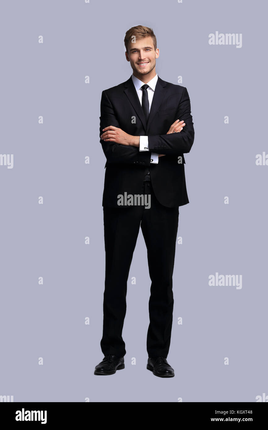 portrait in full growth. successful businessman with arms crossed in ...