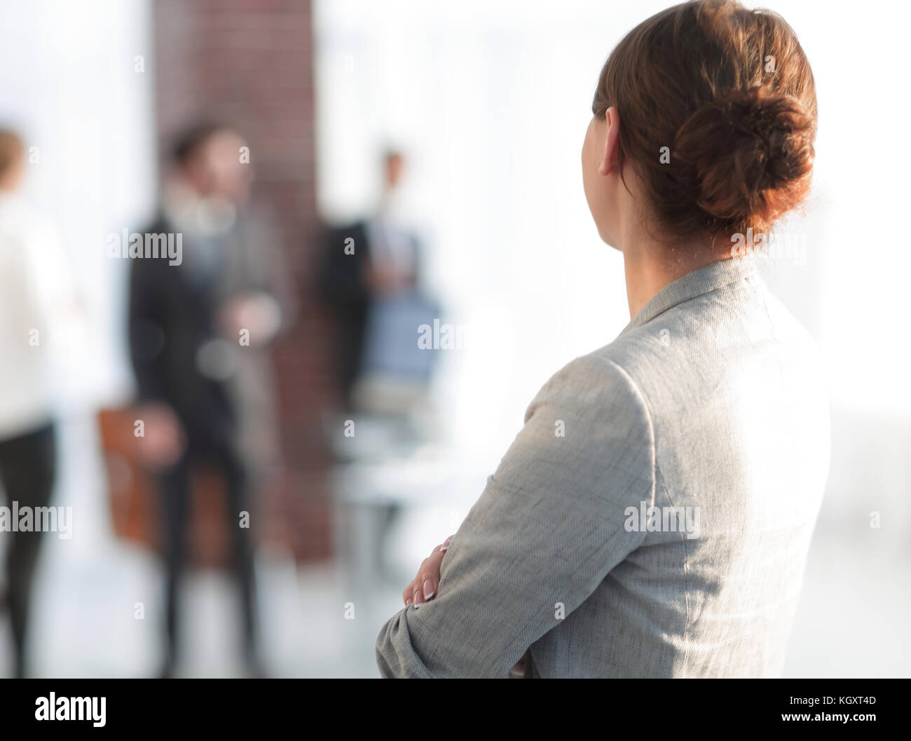 rear view of business woman on blurred background office. Stock Photo