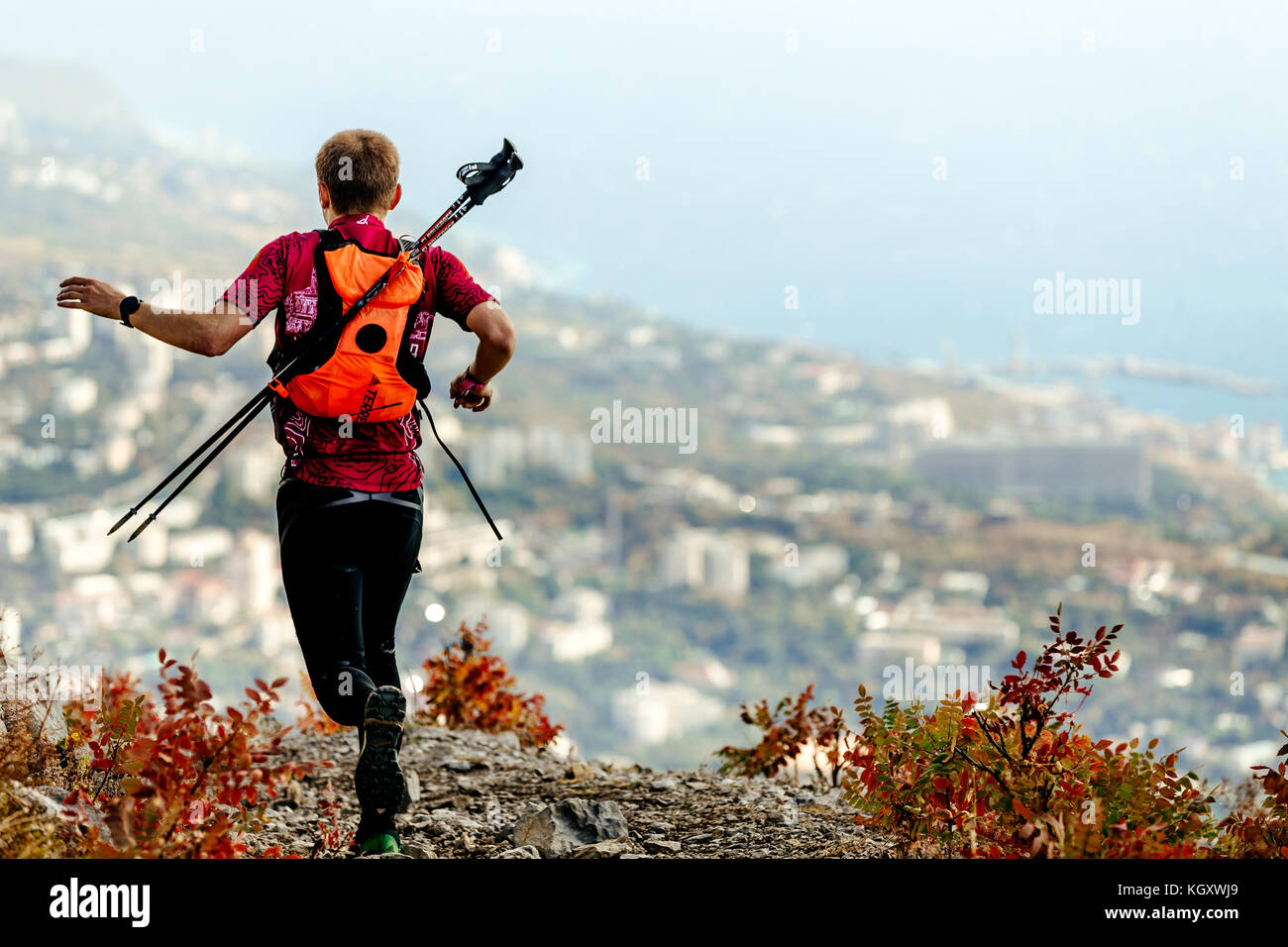 athlete runner with backpack and trekking sticks running in mountains Stock  Photo - Alamy