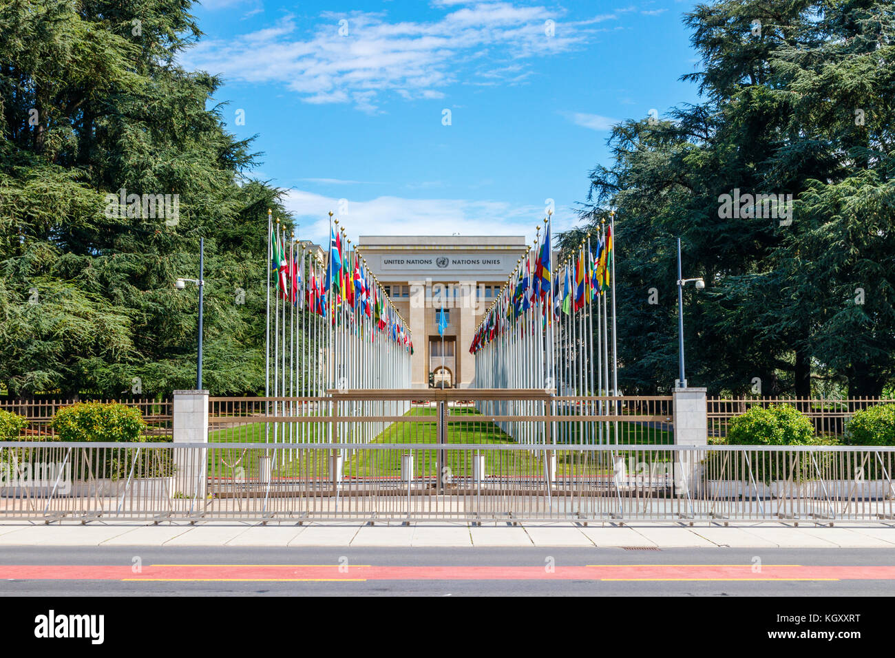 Square of the Nations with the Geneva United Nations Palace, with the flags of the member countries, guarded with a fence and cameras. Switzerland. Stock Photo