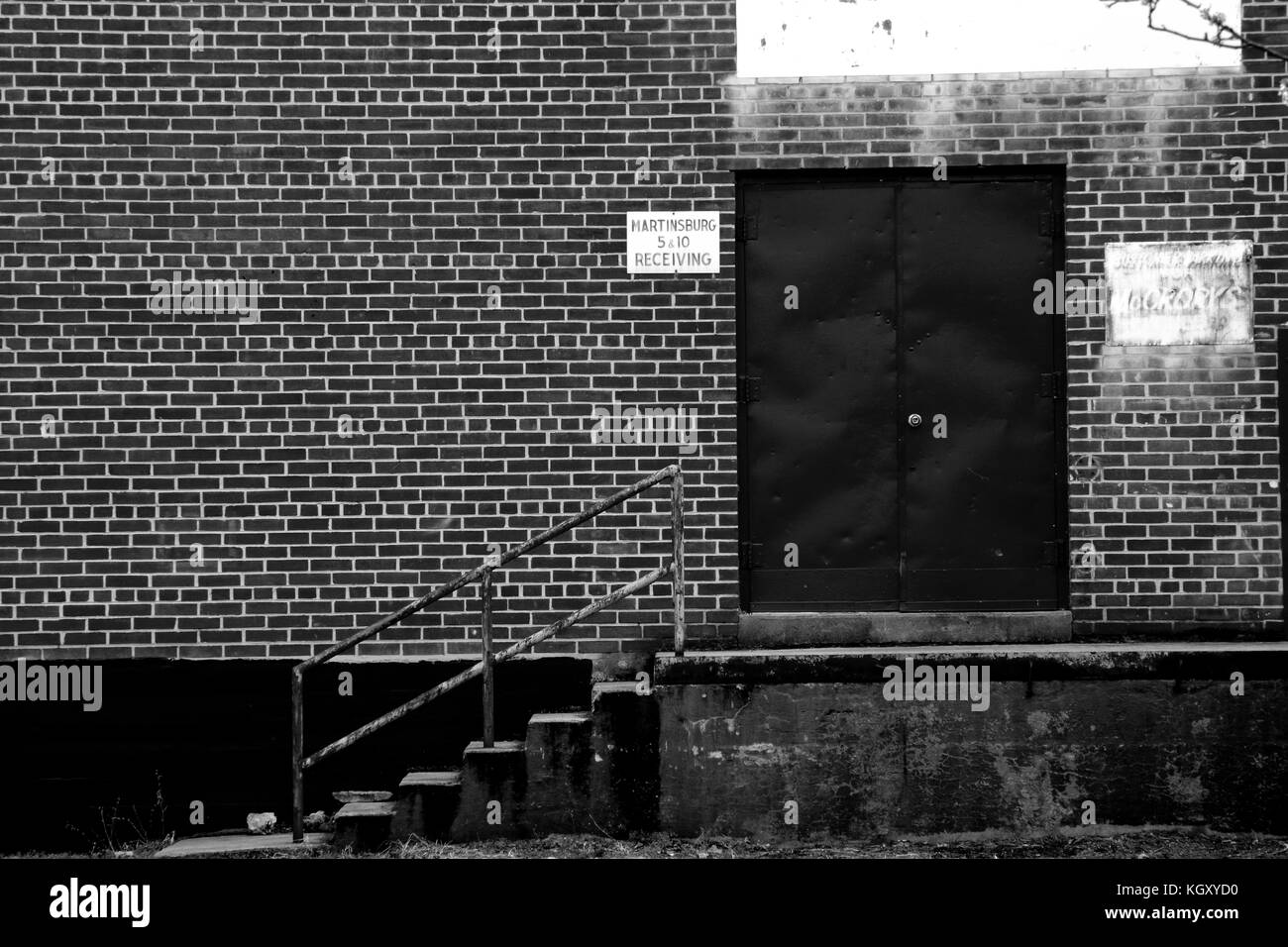 A loading dock behind a row of old storefronts in Martinsburg, West Virginia. Taken in black and white. Stock Photo