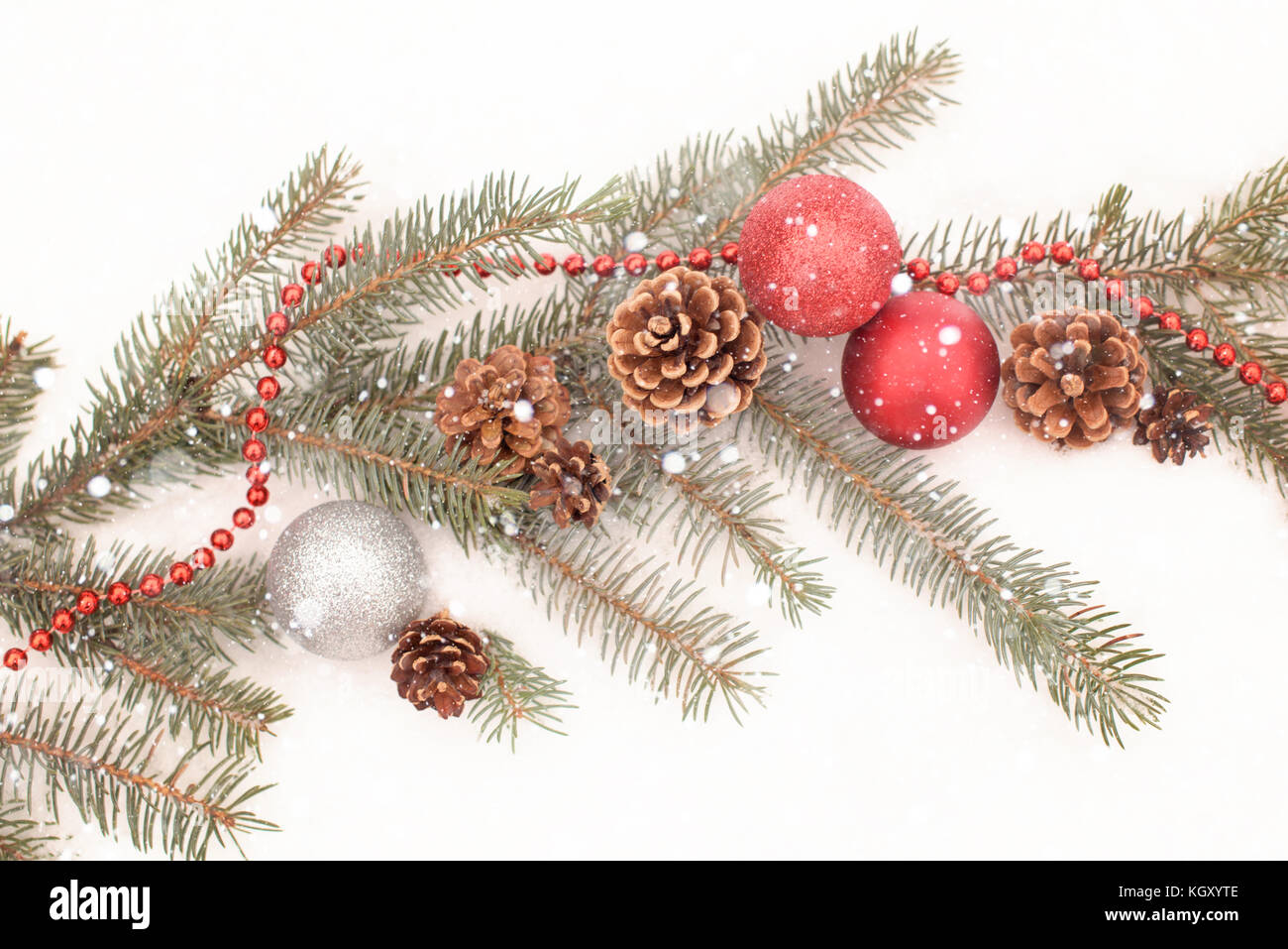 Christmas decoration with pine branch, red and silver balls, cones and