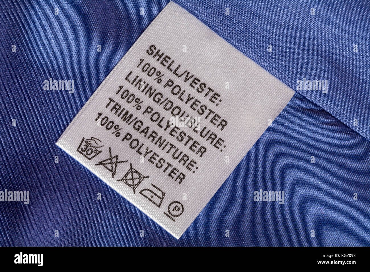 Label in woman's blue jacket - shell 100% polyester lining 100% polyester trim 100% polyester with wash care symbols Stock Photo