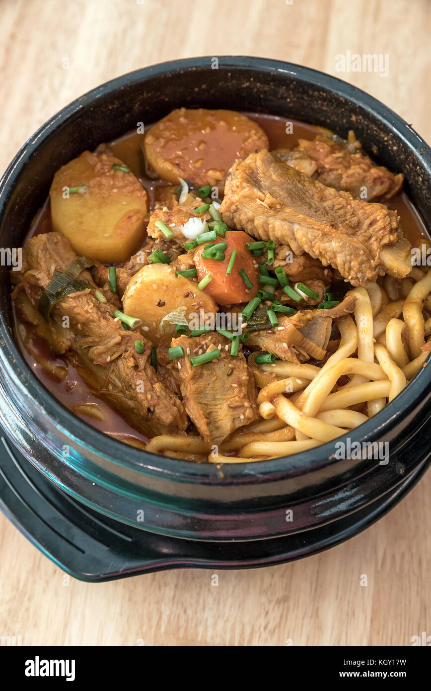 Gamjatang Korean Spicy Pork rib Soup with Kimchi and udon Stock Photo
