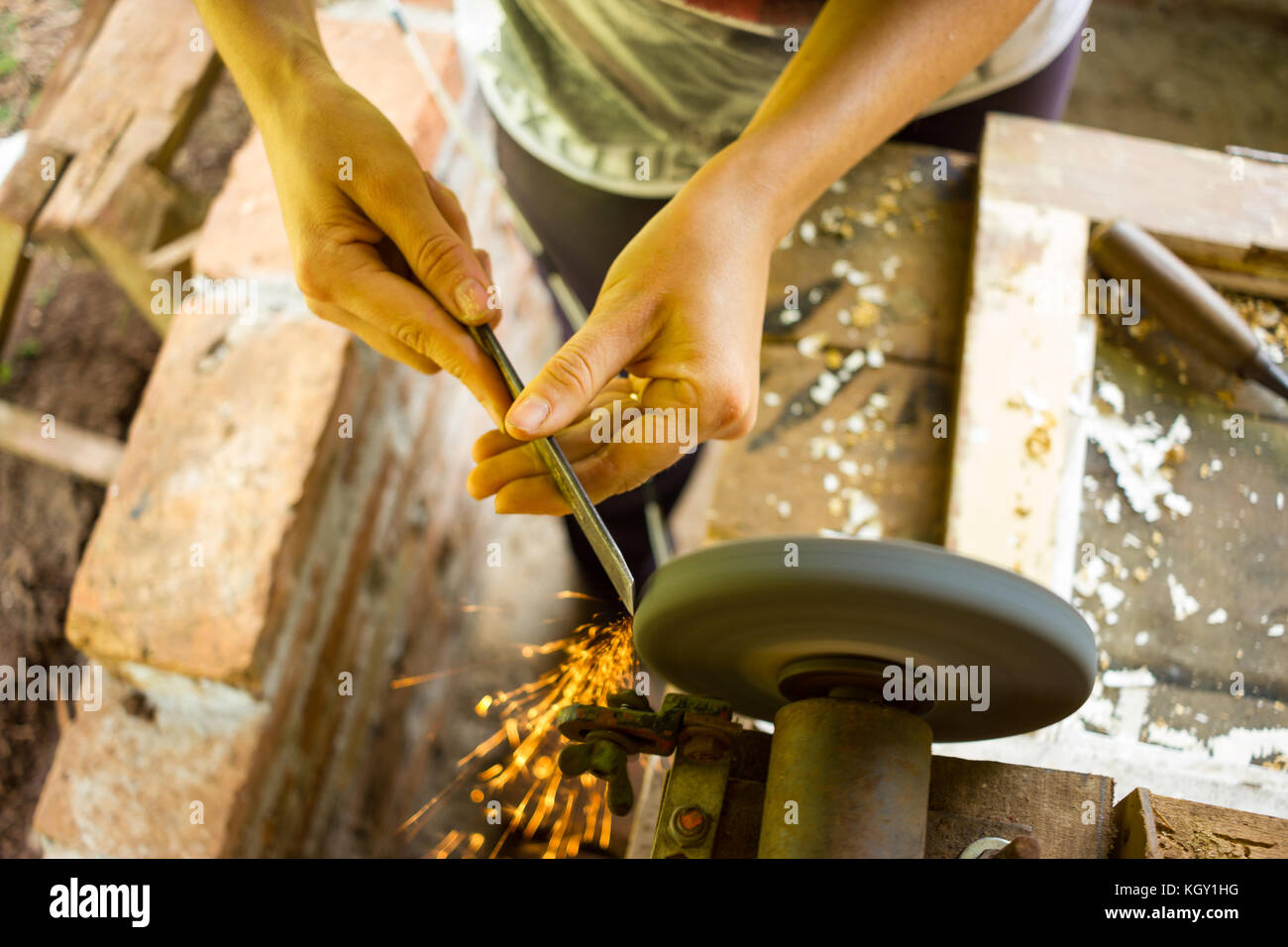 Female hand sharpening tool with a Circular Sharpener Stock Photo Alamy