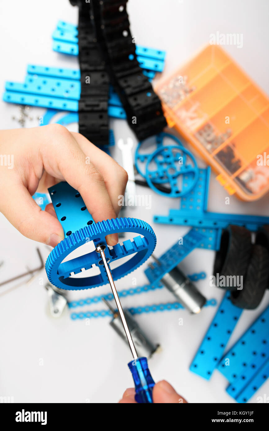 Assemble of DIY kit close up view. Hands making RC model Stock Photo