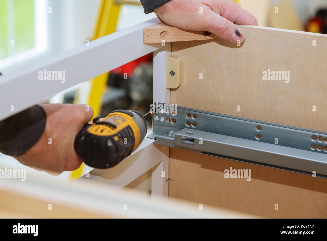 A workman fixing with screwdriver in kitchen kitchen Stock Photo Alamy