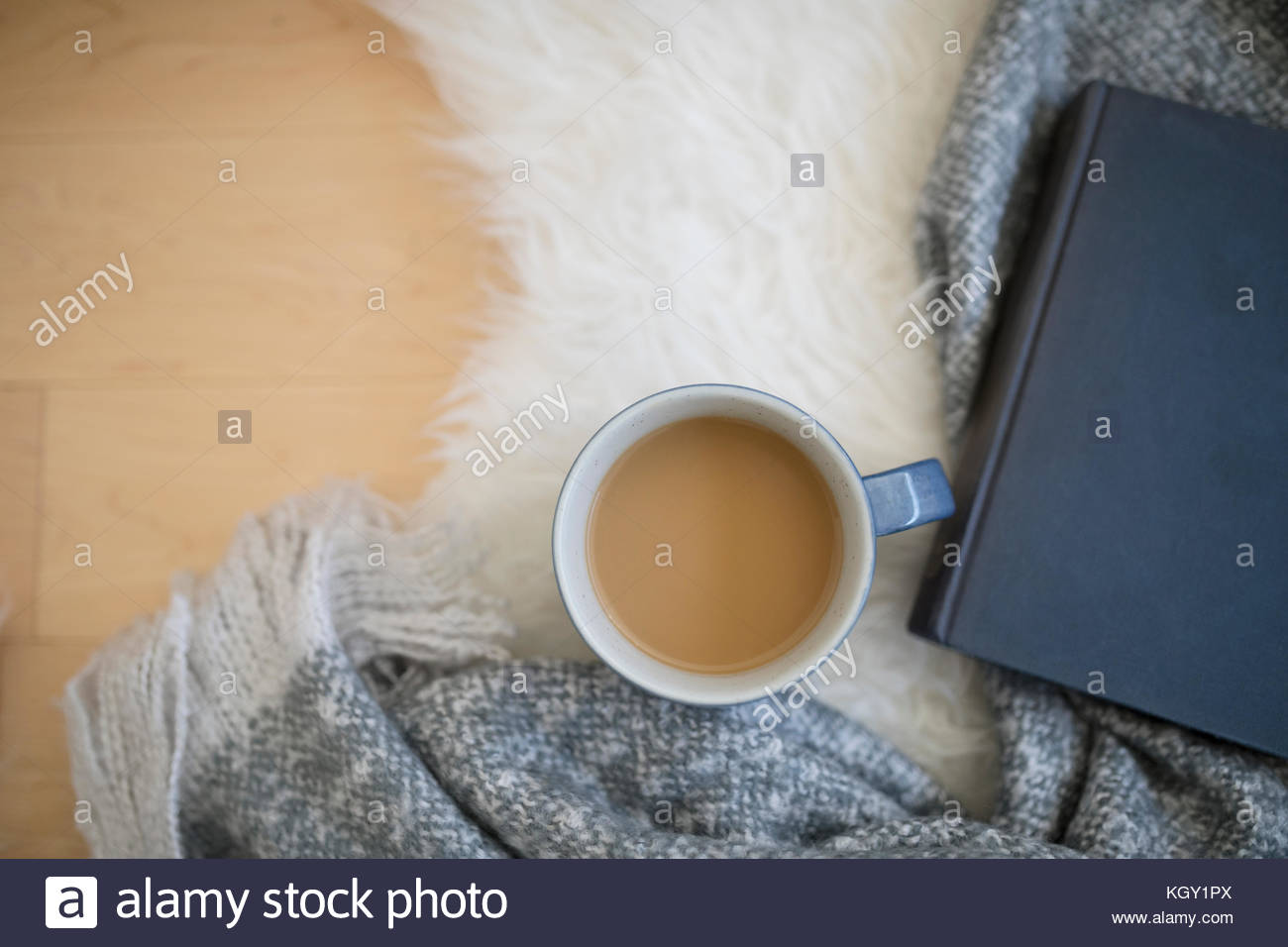 Overhead view coffee and book on blanket Stock Photo Alamy