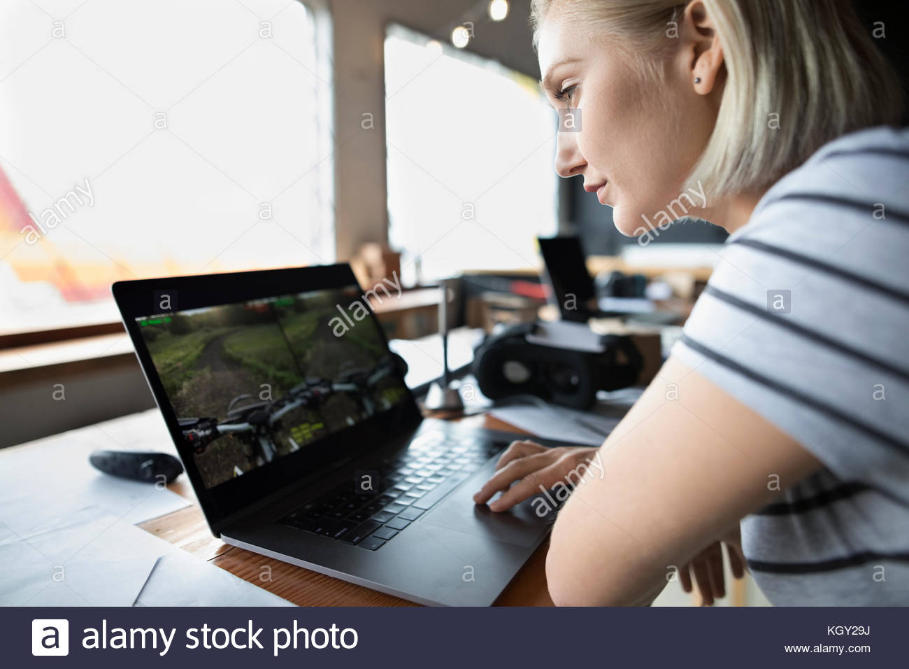 Female computer programmer programming virtual reality simulator at laptop Stock Photo