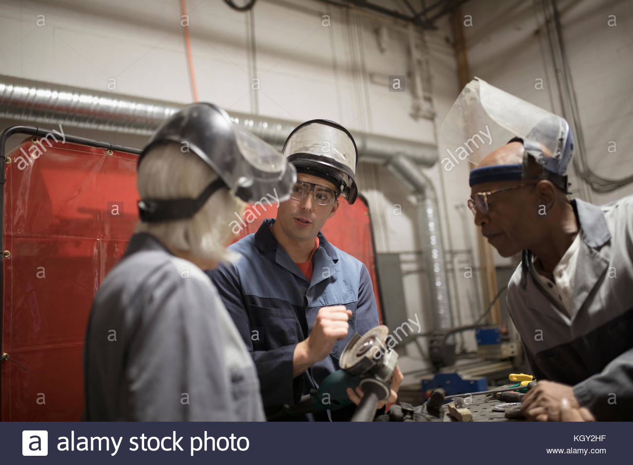 Welders talking in workshop Stock Photo - Alamy