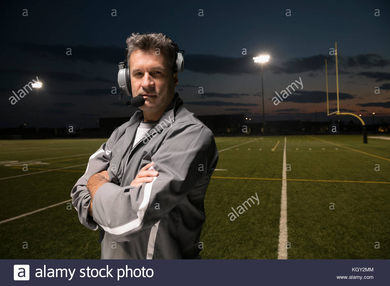 Portrait confident, tough high school football coach wearing headset on