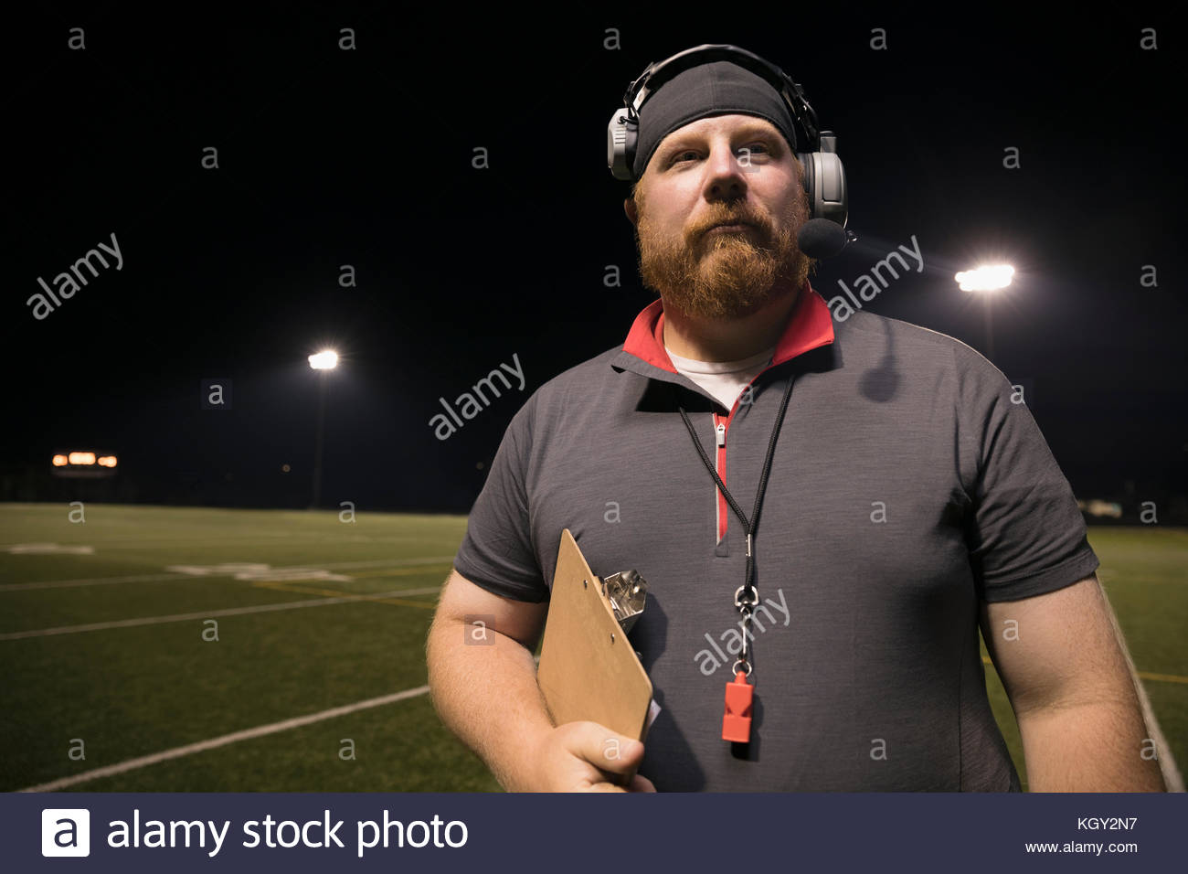 Portrait confident high school football coach with clipboard wearing