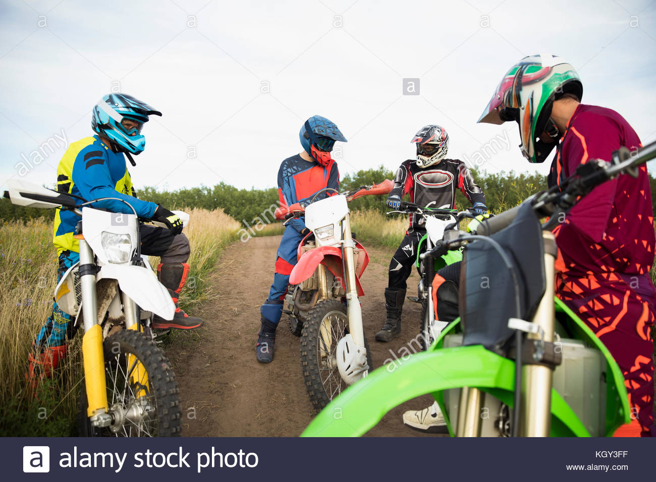 Male friends on motorbikes talking on rural dirt road Stock Photo Alamy