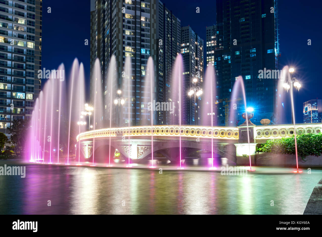 A state of the art fountain at night with colorful lights shimmering ...