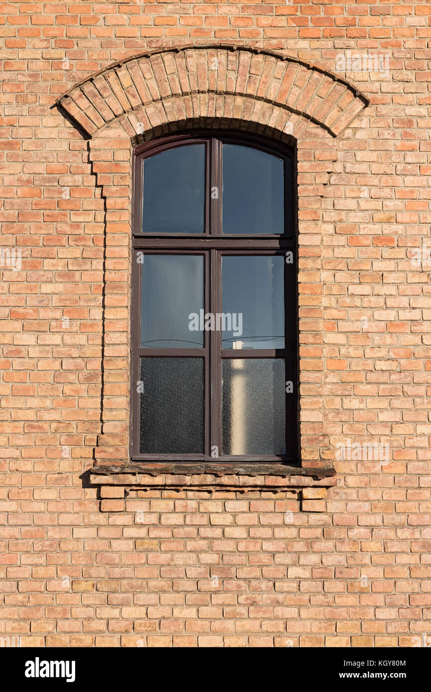 Old brick building with window with little arch above Stock Photo