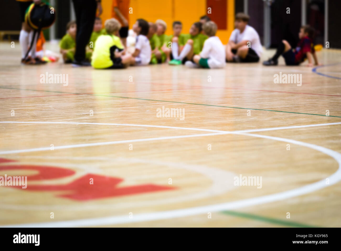 Physical Education Class. Indoor Soccer Training. Kids Futsal Team with Coach. Youth Sport Background Stock Photo