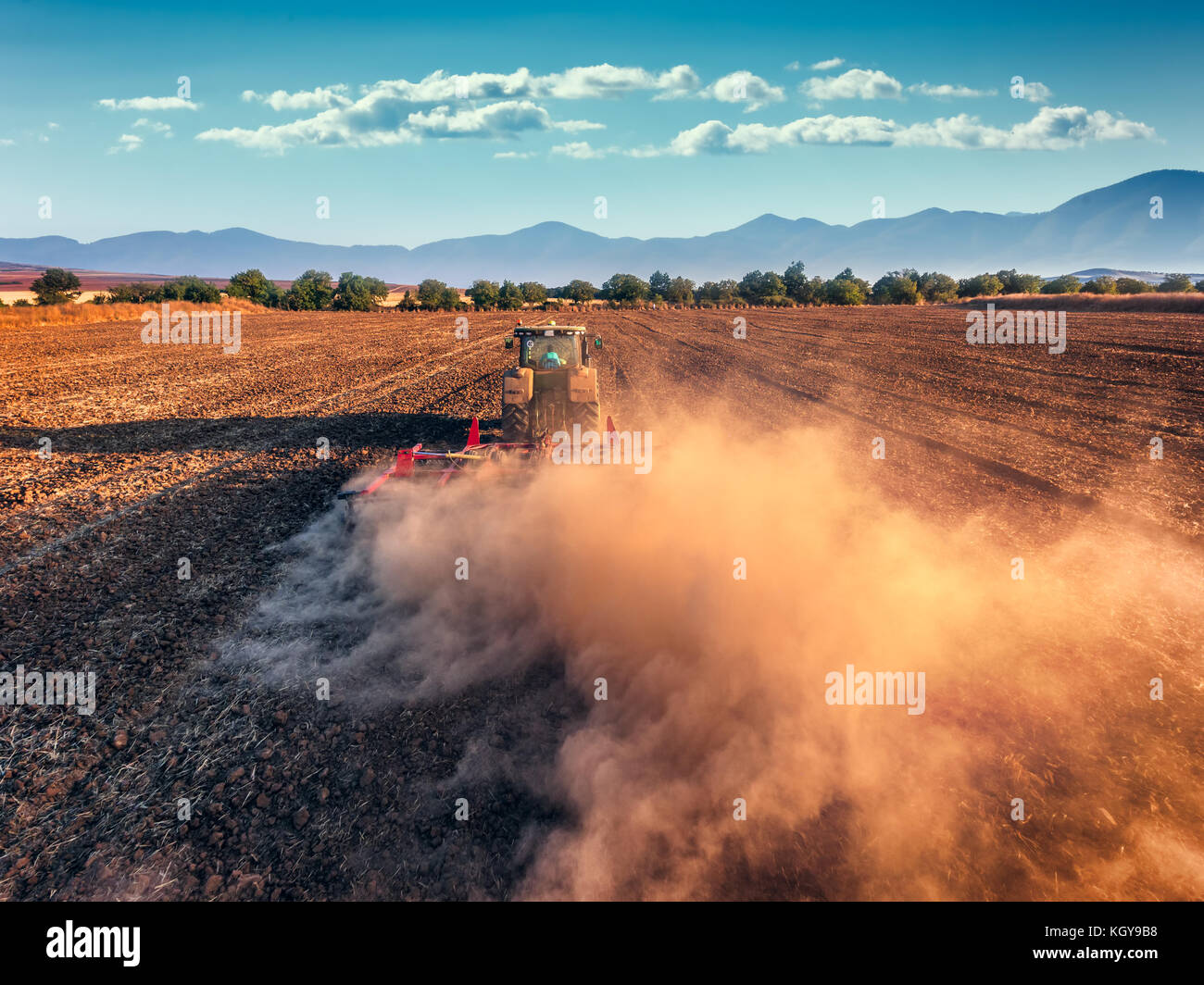 Tractor cultivating field at autumn ,aerial view Stock Photo