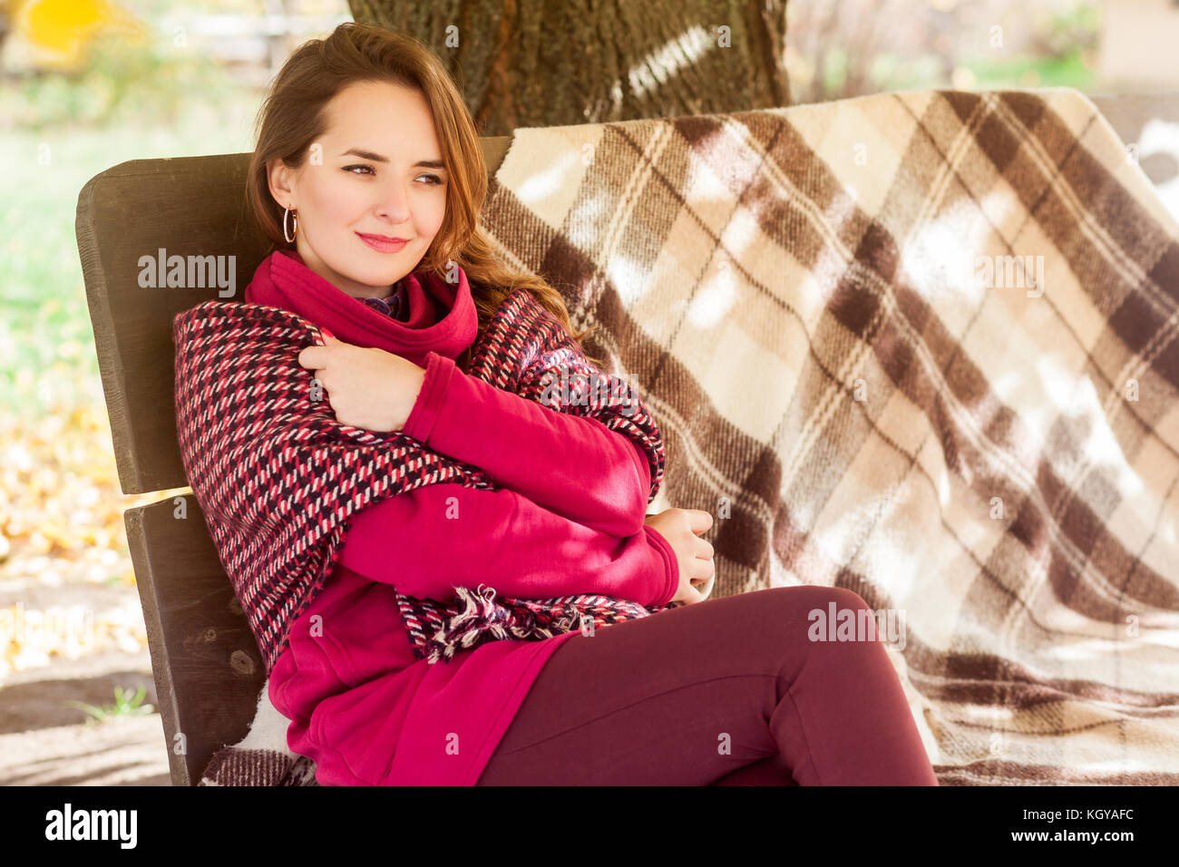Fall, autumn concept. Happiness woman frozen and embraces himself. Outdoor shot in park Stock Photo
