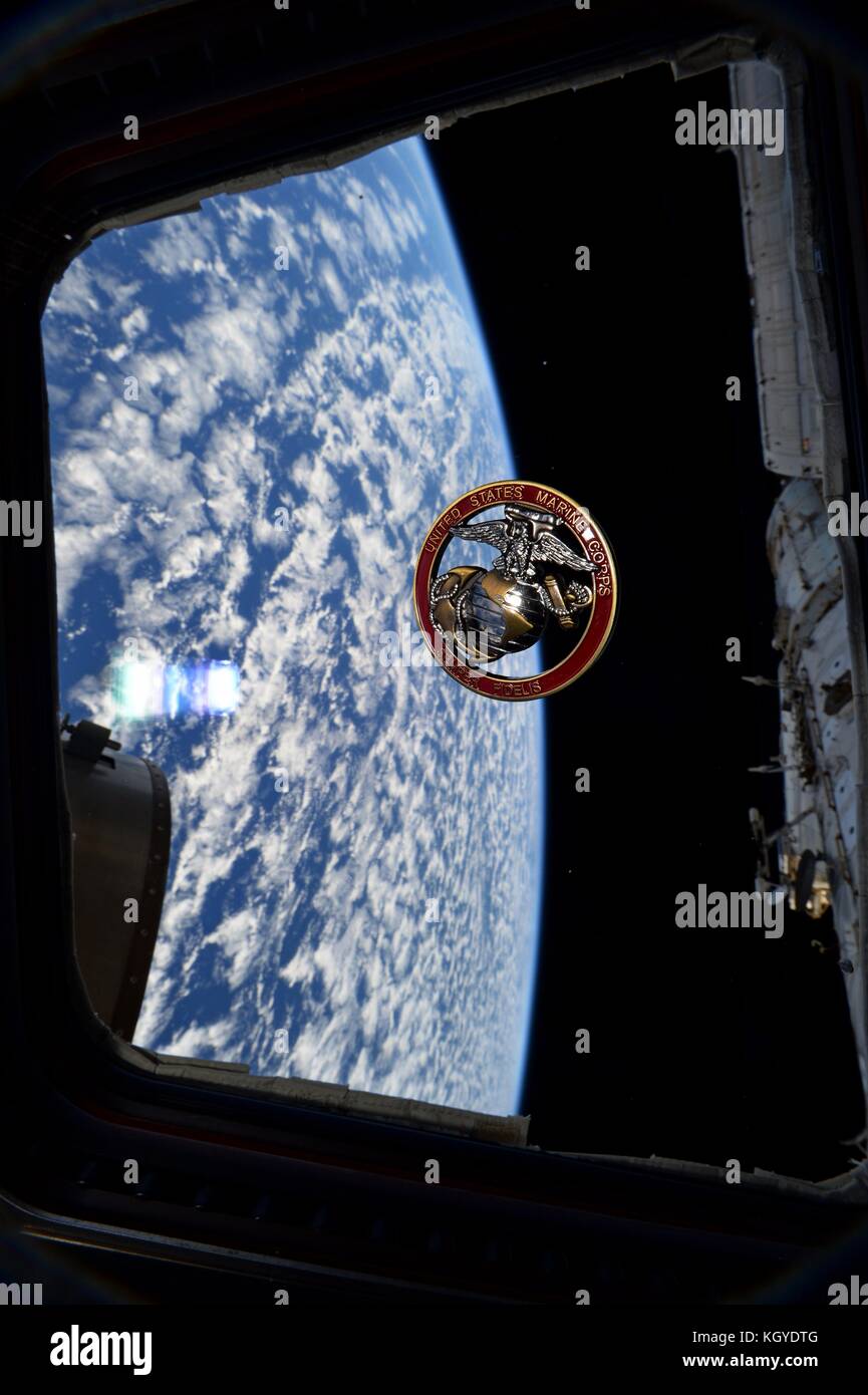 International Space Station. 10th Nov, 2017. Expedition 53 American astronaut Randy Bresnik celebrates the birthday of the U.S. Marine Corps by flying a USMC coin in the cupola of the International Space Station for storage November 10, 2017 in Earth Orbit. Credit: Planetpix/Alamy Live News Stock Photo