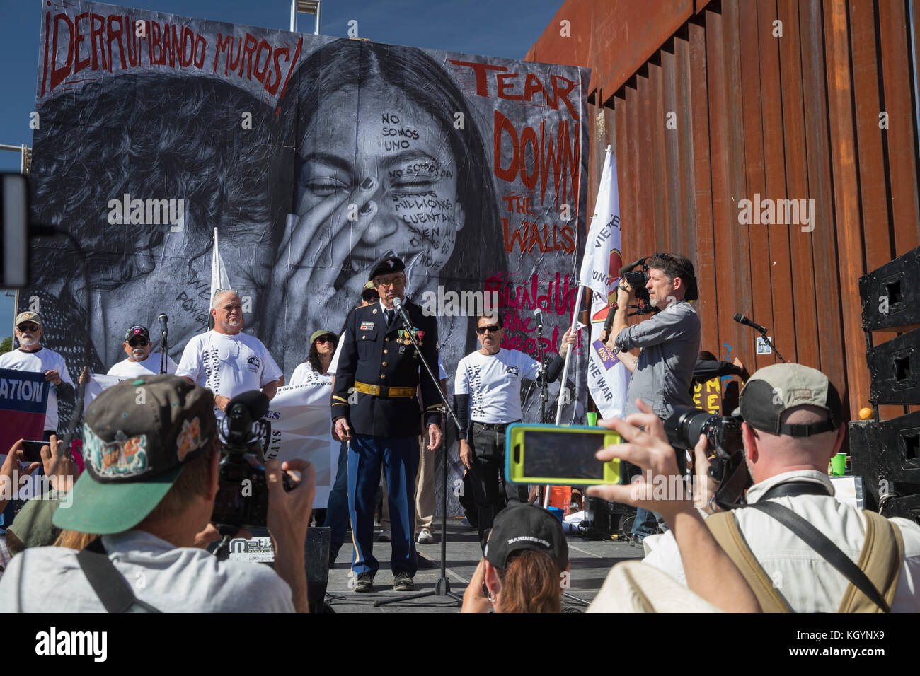 Nogales, Arizona USA and Nogales, Sonora Mexico - 11 November 2017 - On Veterans Day, members of Veterans for Peace led a march and rally on both sides of the U.S.-Mexico border fence to protest the separation of immigrant families, U.S. policies that make it hard for refugees fleeing repression to enter the United States, and the deportation of veterans who have served in the U.S. military. The events were organized by the School of the Americas Watch, a group of religious and community activists. Stock Photo