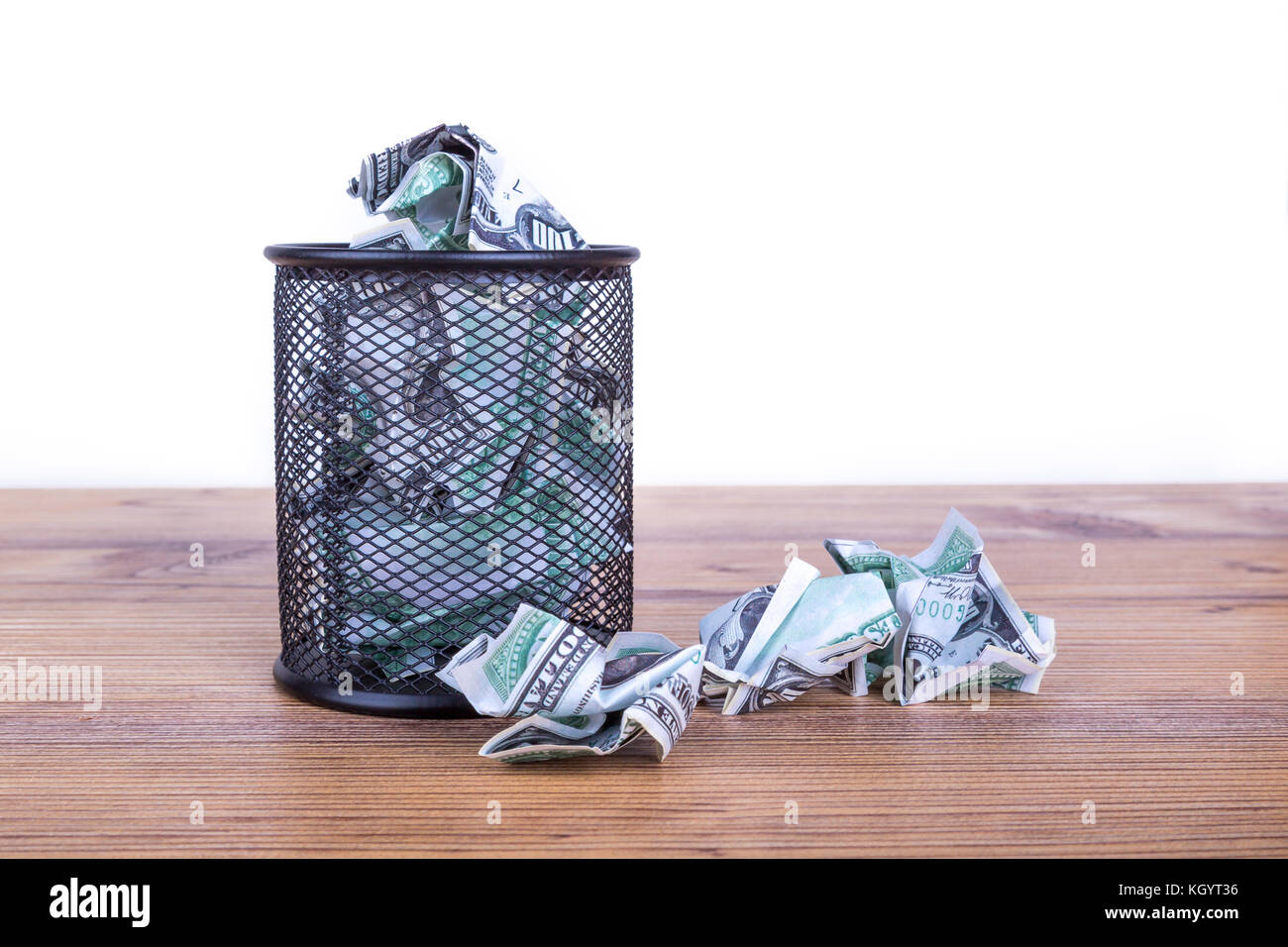 Dollar banknotes crumpled inside garbage basket, rubbish bin focused on ...