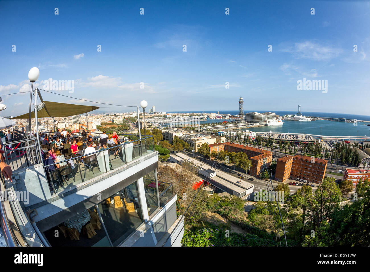 Customers in an open air cafe on Montjuric over looking Port Vell,Barcelona,Spain. Stock Photo