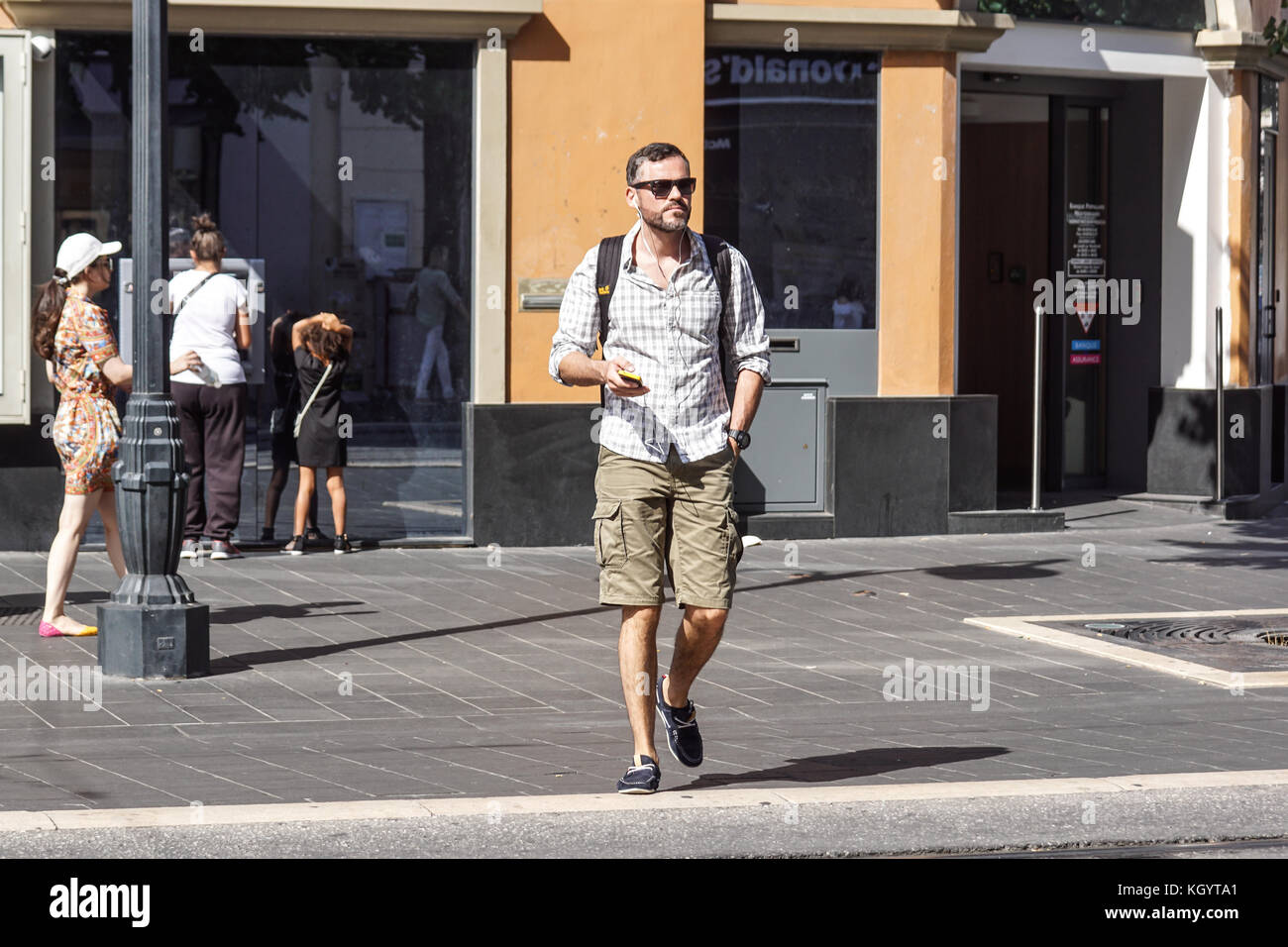 Nice , France 15 August 2017 : A man listening music while walking on street in Nice center ville Stock Photo