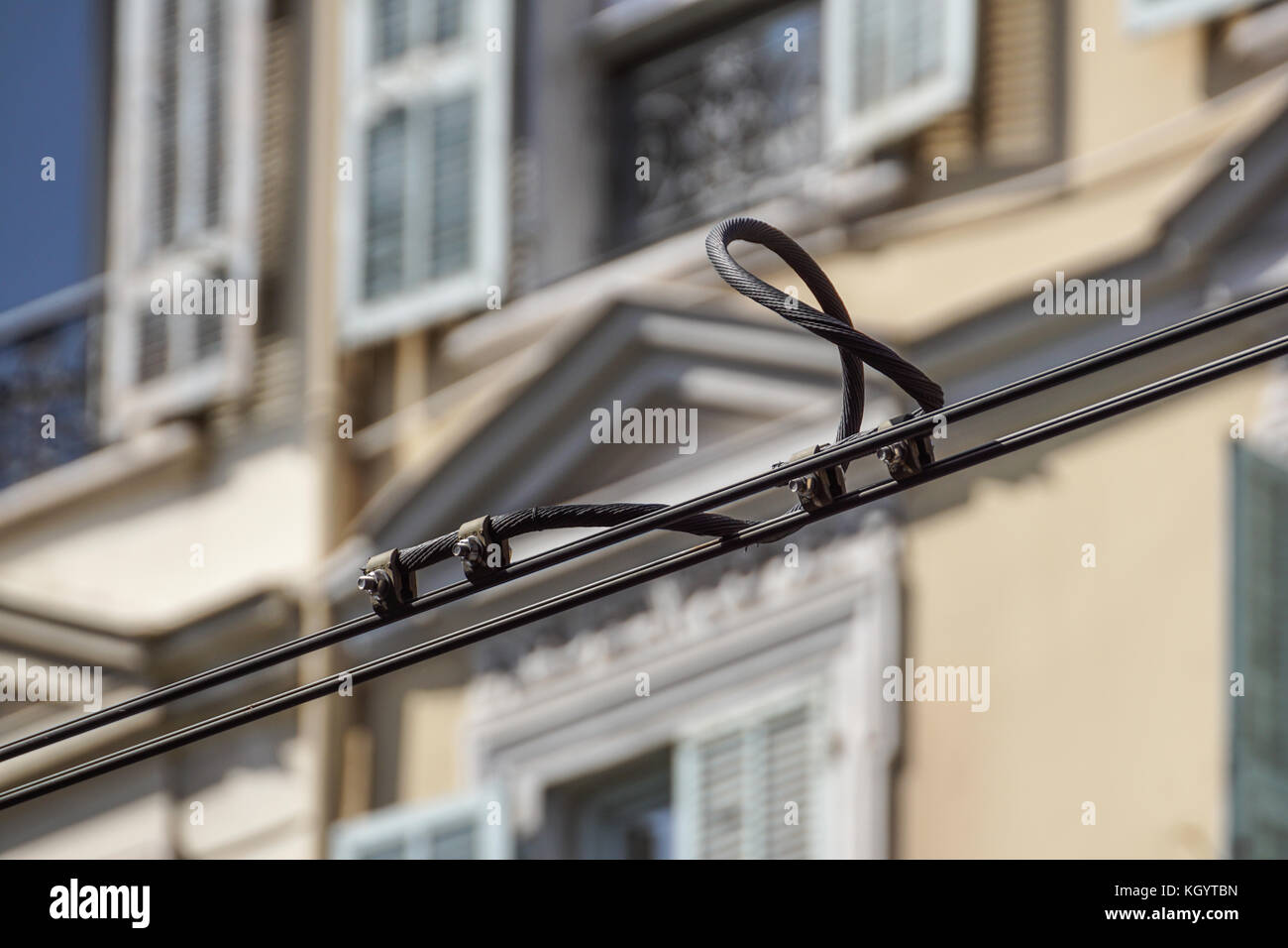Black tram wires detail over urban facade Stock Photo