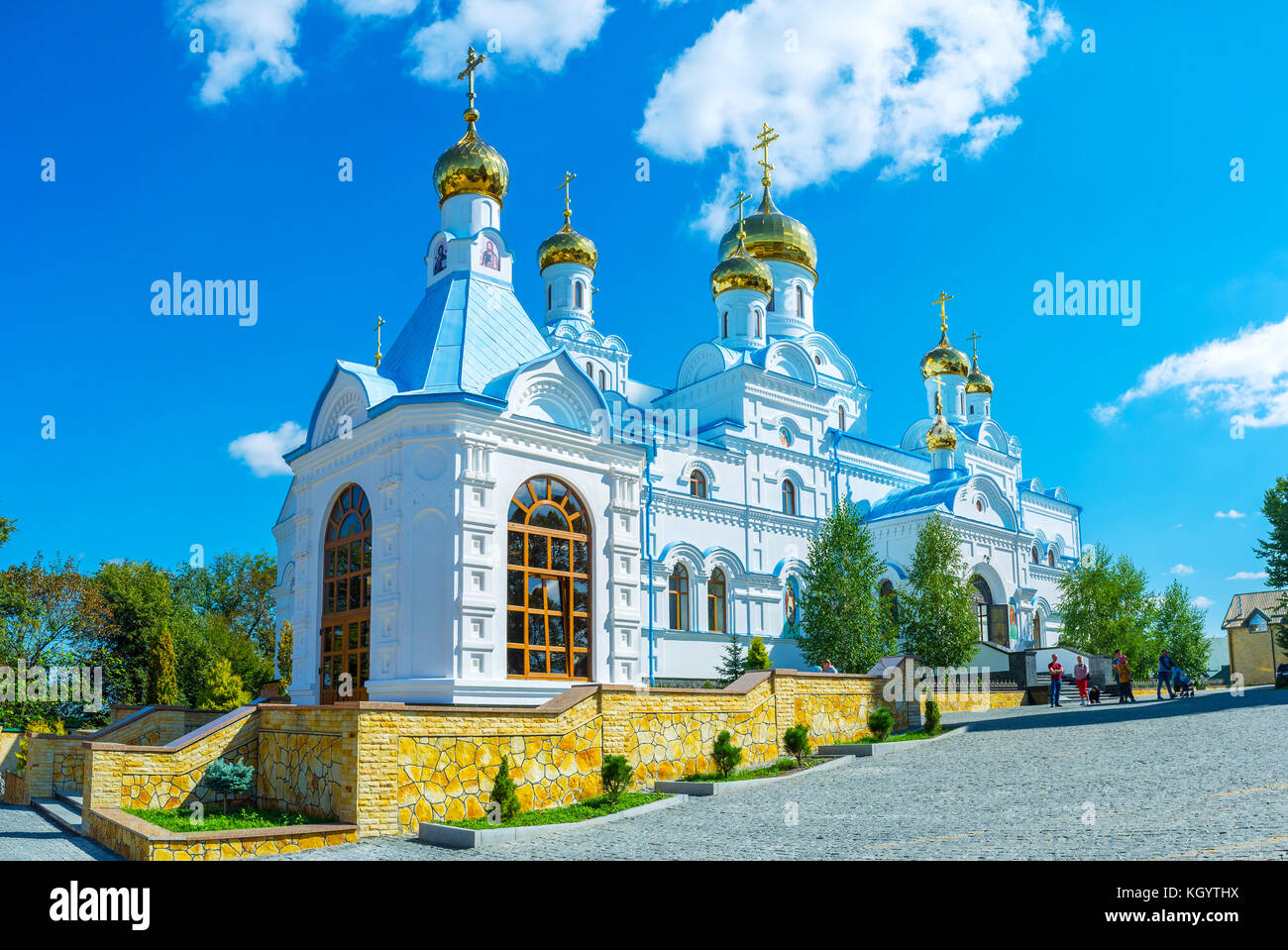 POCHAYIV, UKRAINE - AUGUST 30, 2017: Beautiful white All Saints Church impress with its carved architecture , on August 30 in Pochayiv. Stock Photo