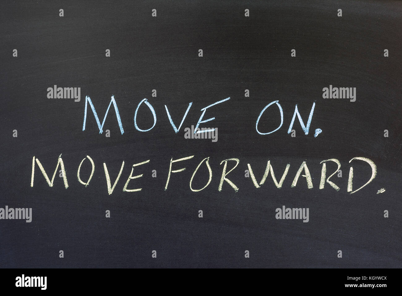 Move On and Move Forward written on a dark colored background. Stock Photo