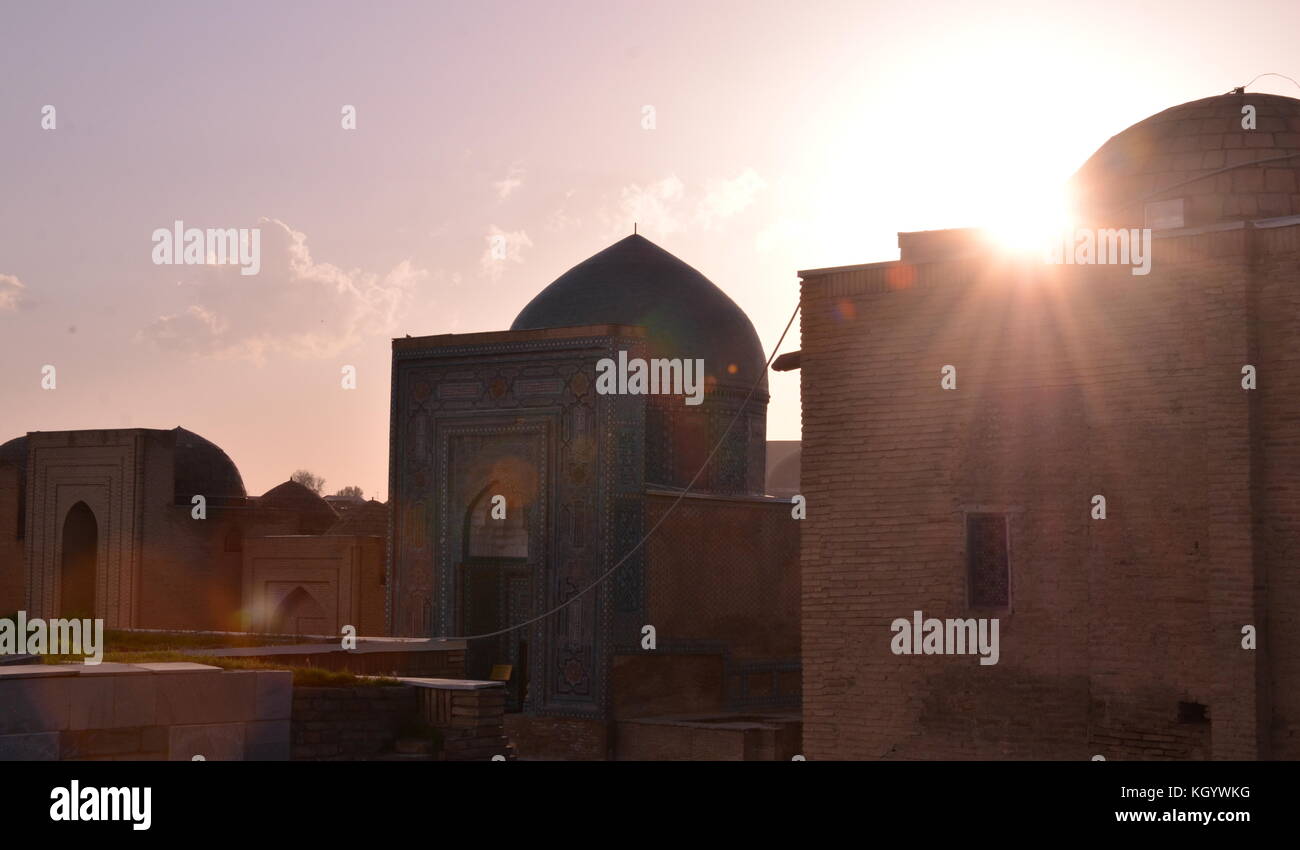 Shah-i-Zinda Necroplis with muslim cemetery with mausoleums, tombs and graves during sunset. Stock Photo