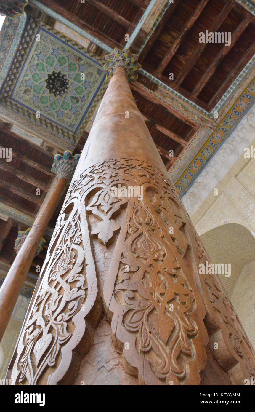 Slim wooden carved pillars of Bolo Hauz mosque in Bukhara, Uzbekistan. Stock Photo