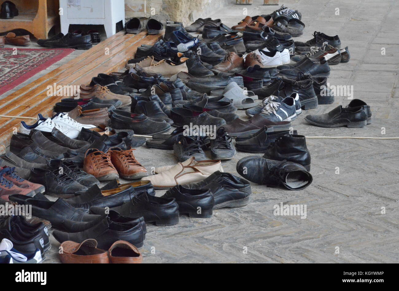 men shoes in front of the Bolo Hauz mosque in Bukhara, Kazakhstan. Stock Photo
